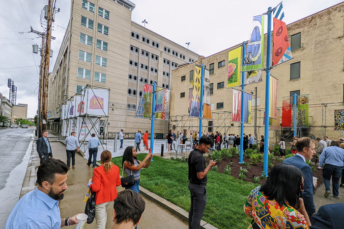 Pop Park featuring Social Sculpture by Michael Loveland; with a few people standing in the foreground and around the perimeter of Pop Park