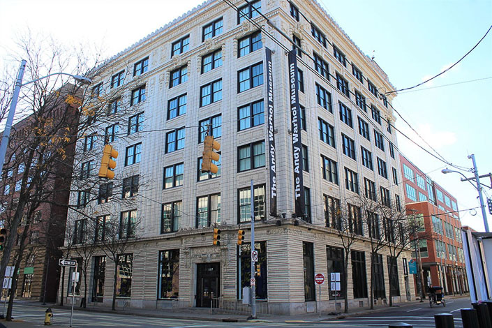 Street level photo of the Andy Warhol museum on a sunny day.